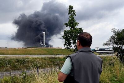 An onlooker watches as smoke rises from the Chempark blast which reportedly was felt up to 40 kilometres away. AFP