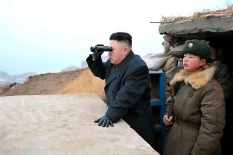 The North Korean leader Kim Jong-un at an observation post on the border with South Korea. In a digital world, author Andrei Lankov predicts Kim cannot continue his isolationist regime for much longer. AP Photo / KCNA via KNS