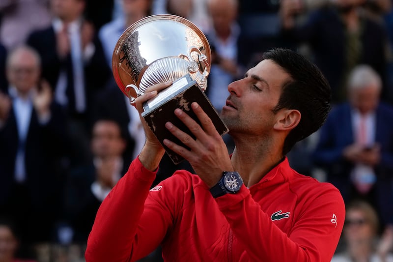 Serbia's Novak Djokovic kisses the trophy after winning the Italian Open final against Greece's Stefanos Tsitsipas in Rome on May 15, 2022. AP