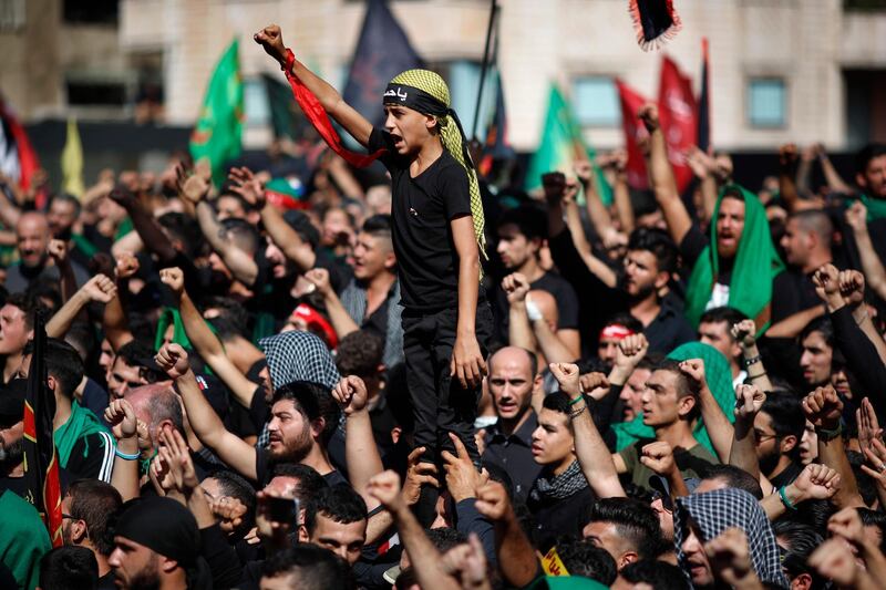Lebanese Shiite supporters of Hezbollah shouts slogans against the U.S and Israel during activities marking the holy day of Ashoura, in southern Beirut, Lebanon, Sunday, Oct. 1, 2017. Ashoura is the annual Shiite Muslim commemoration marking the death of Imam Hussein, the grandson of the Prophet Muhammad, at the Battle of Karbala in present-day Iraq in the 7th century. (AP Photo/Hassan Ammar)