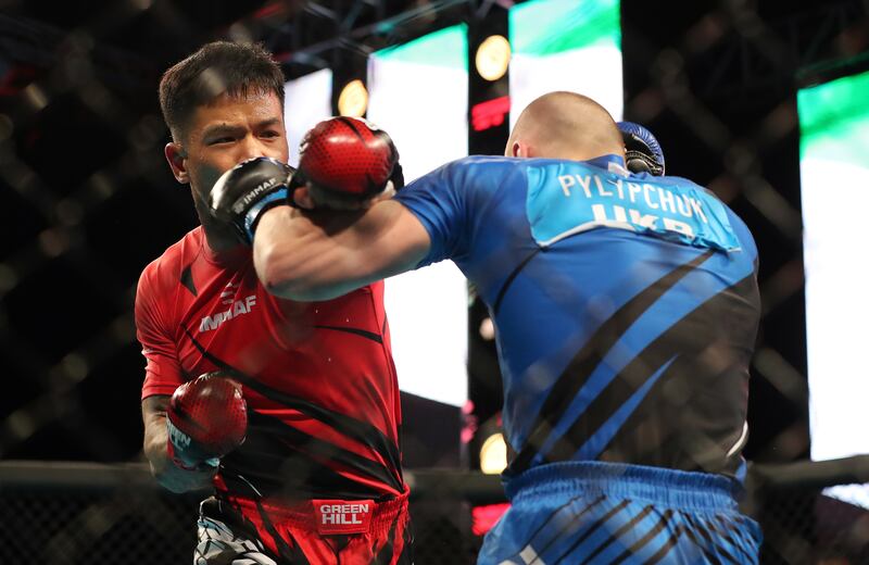 Ukraine's Roman Pylypchuk, in blue, during his fight against Michale Lisan of French Polynesia in the men's welterweight category.
