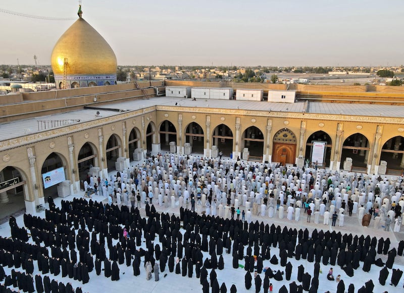 Iraqis perform Eid Al Adha prayers at the Great Mosque of Kufa, 10km north-east of the city of Najaf.