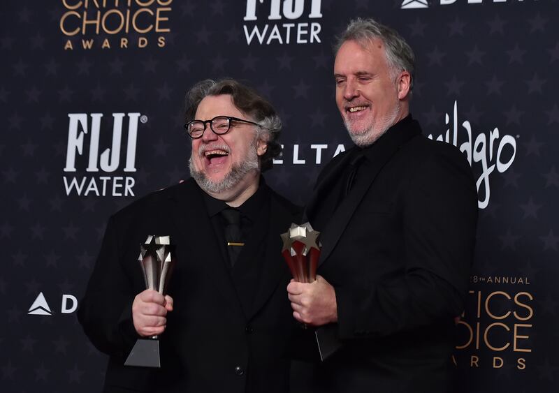 Guillermo del Toro, left, and Mark Gustafson with the award for Best Animated Feature for Guillermo del Toro's Pinocchio. AP