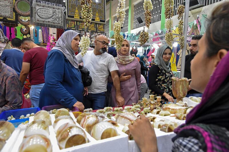 People shop for ornaments at a pavilion during the Mosul International Shopping Festival in Iraq's northern city.  AFP