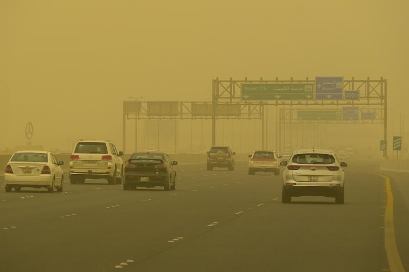 Vehicles shrouded in heavy dust in Kuwait City during a storm. EPA