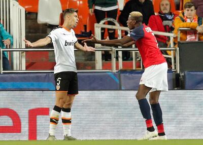 epa07975271 Valencia CF's defender Gabriel Paulista (L) and Losc Lille's Victor Osimhen (R) during a UEFA Champions League soccer group stage match between Valencia CF and Losc Lille played at Mestalla stadium in Valencia, Spain, 05 November 2019.  EPA/Kai Foersterling