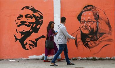 epaselect epa07244485 Bangladeshi people walk along a street past a mural showing Bangladesh Awami League (AL) Party's president Sheikh Hasina (R) and founder Bangabandhu Sheikh Mujibur Rahman portrait ahead of national polls in Dhaka, Bangladesh, 22 December 2018. According to the Bangladesh Election Commission, the 11th general election is scheduled on 30 December 2018 to select members of the national parliament, also known as Jatiya Sangsad.  EPA/MONIRUL ALAM