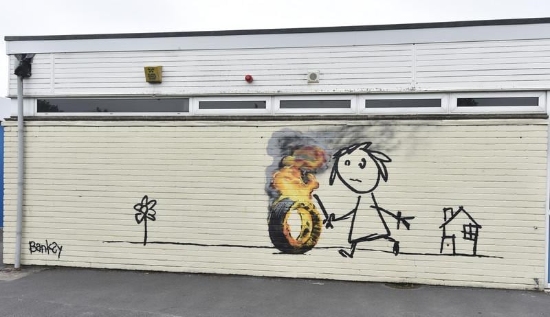 epa05349563 The Bridge Farm Primary School where a new 'Banksy' authenticated mural appeared on the school wall during half term in Withchurch, Britian, 07 June 2016. The mural, which has been authenticated by the artist PR is a thanks to the school for naming a school wing after him.  EPA/NEIL MUNNS