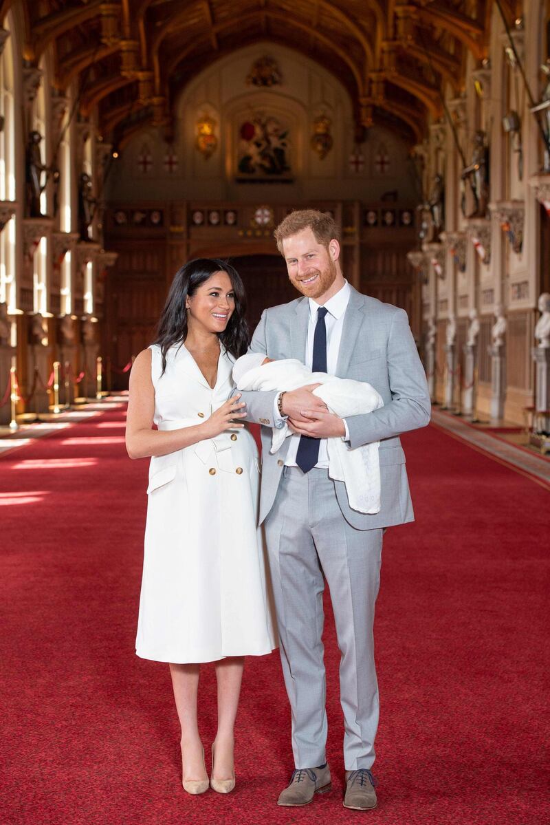 Britain's Prince Harry, Duke of Sussex and Meghan, Duchess of Sussex, pose for a photo with their newborn baby son in St George's Hall at Windsor Castle in Windsor, west of London on May 8, 2019. AFP
