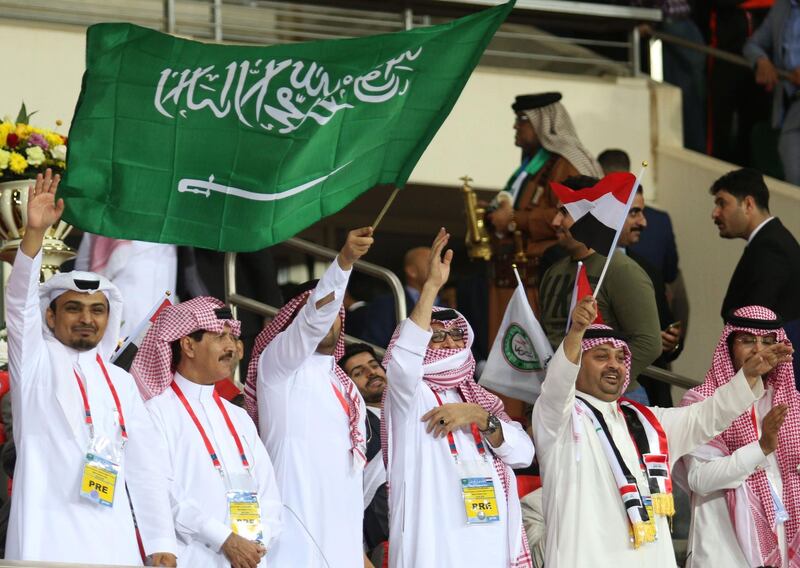 Fans wave the Saudi Arabian flag prior to the start of the match. Haidar Mohammed Ali / AFP