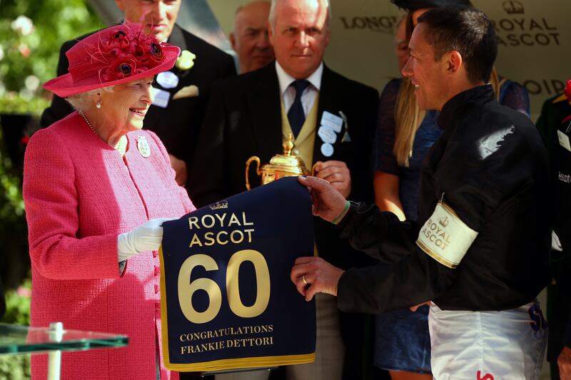 Queen Elizabeth presents jockey Frankie Dettori with his award for winning The Gold Cup at Royal Ascot in 2018. Getty Images