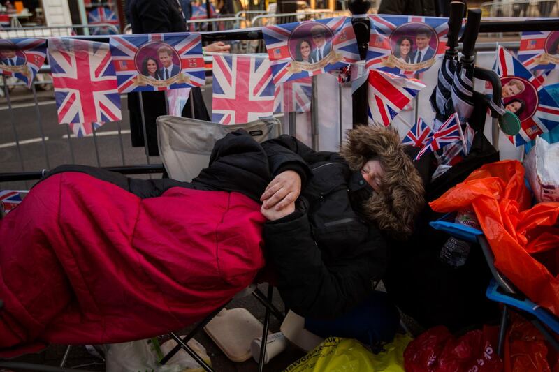 A woman sleeps in front of Windsor Castle. Emilio Morenatti / AP Photo