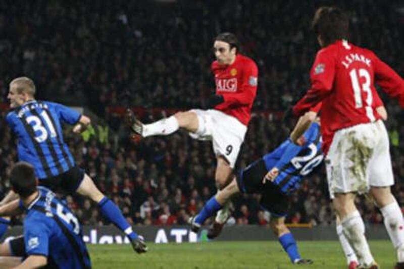 Manchester United's Dimitar Berbatov, centre, scores against Middlesbrough to seal a 1-0 win.