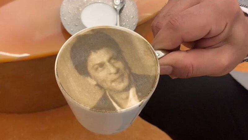 Bollywood star Shah Rukh Khan shared video of himself sipping coffee with his face on it. 