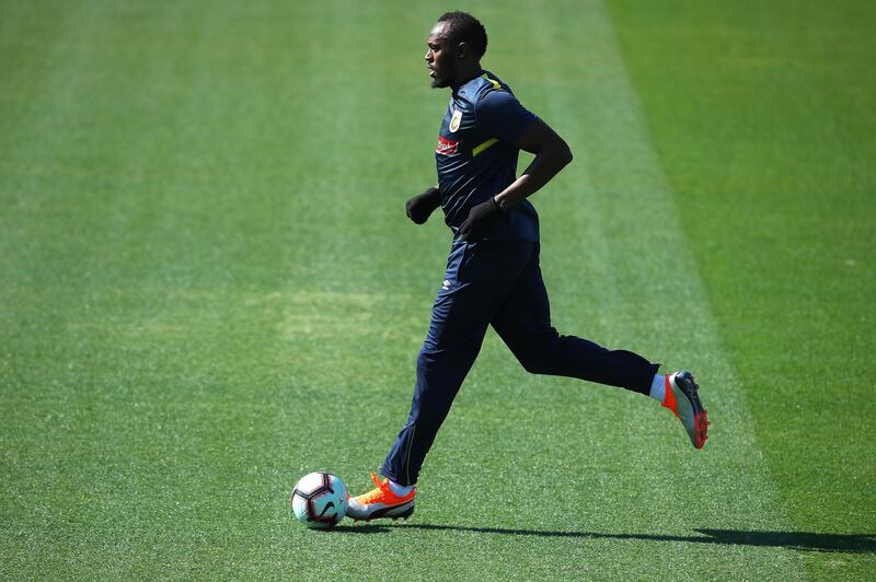 Usain Bolt dribbles the ball during the training session. Getty Images