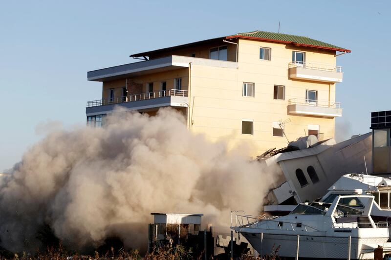 The Albanian Army uses a controlled blast to destroy an earthquake-damaged building in Durres, Albania. Reuters