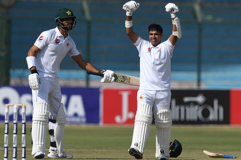 Pakistan's Abid Ali, right, celebrates with teammate Shan Masood after reaching his century during the third day of the second Test against Sri Lanka, at the National Stadium in Karachi, on December 21, 2019. It was Pakistan's first Test series at home for more than  10 years AFP