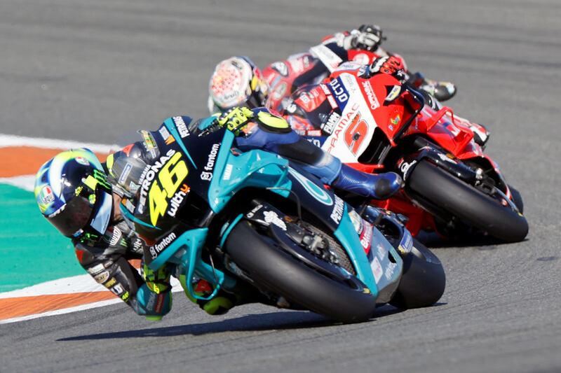 Valentino Rossi, left, steers his motorbike during his last professional race in Valencia. EPA