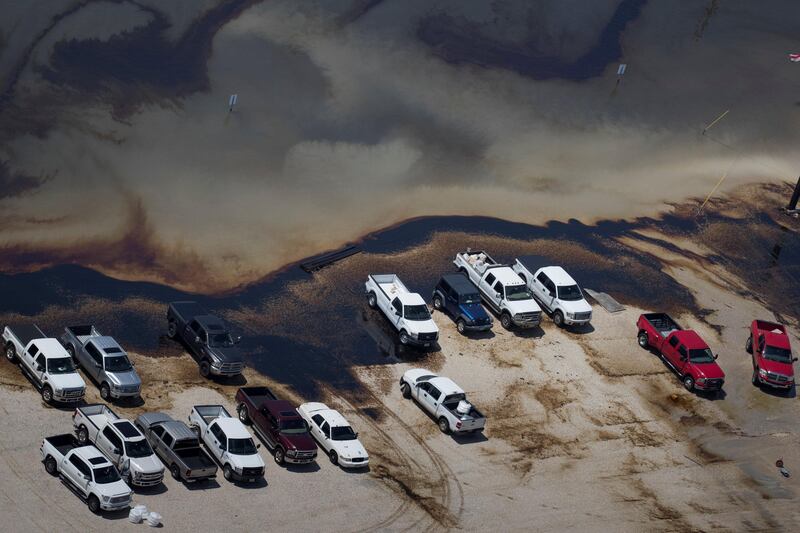 Vehicles sit amid leaked fuel mixed in with flood waters caused by Tropical Storm Harvey in the parking lot of Motiva Enterprises LLC in Port Arthur, Texas, U.S. August 31, 2017. REUTERS/Adrees Latif