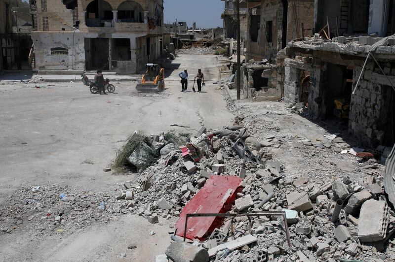 A bulldozer clears debris from the streets in Deraa, Syria July 25, 2017. REUTERS/Alaa Al-Faqir