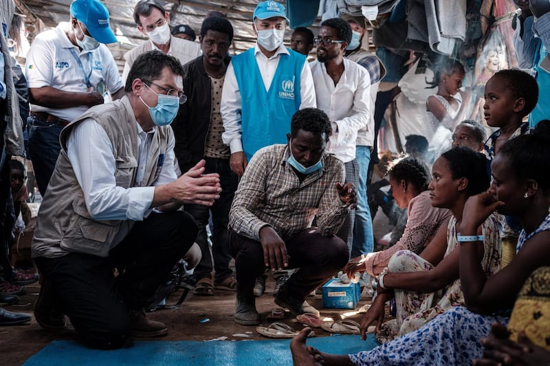 Janez Lenarcic (L), European Commissioner for Crisis Management, speaks with Ethiopian refugees who fled the Tigray conflict during his visit to Um Raquba reception camp in Sudan's eastern Gedaref state on December 3, 2020. - More than 45,000 people have escaped from northern Ethiopia since November 4, after Prime Minister Abiy Ahmed ordered military operations against leaders of Tigray's ruling party in response to its alleged attacks on federal army camps. (Photo by Yasuyoshi CHIBA / AFP)