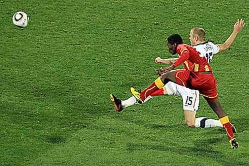 Jay Demerit of the United States fails to stop Asamoah Gyan of Ghana from scoring his team's second goal in extra time.
