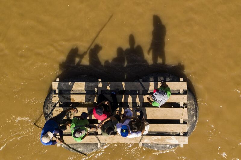 Migrants and residents use a makeshift raft to cross the Suchiate river from Tecun Uman in Guatemala to Ciudad Hidalgo in Chiapas State, Mexico. AFP