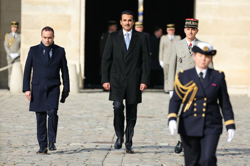 From left, French Minister of the Armed Forces Sebastien Lecornu, Sheikh Tamim and Army Corps General Christophe Abad at an honour ceremony at Les Invalides, Paris. EPA