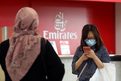 FILE PHOTO: A traveller wears a mask at the Dubai International Airport, after the UAE's Ministry of Health and Community Prevention confirmed the country's first case of coronavirus, in Dubai, United Arab Emirates January 29, 2020. REUTERS/Christopher Pike - RC2JPE94N0K9/File Photo