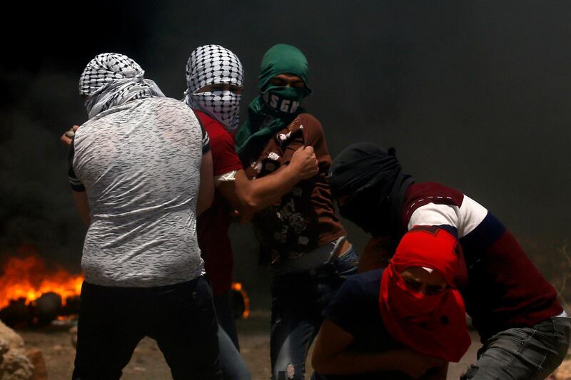 Palestinian protesters face Israeli security forces during clashes in the Israeli-occupied West Bank. AFP