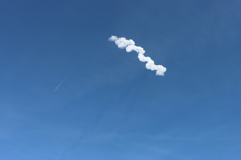 A plume of smoke left behind by a Falcon 9 rocket shortly after lift-off. Sarwat Nasir / The National