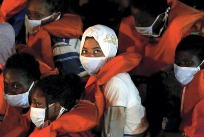 Rescued migrants look on from onboard an Armed Forces of Malta vessel upon their arrival in Senglea, in Valletta's Grand Harbour, as the coronavirus disease (COVID-19) outbreak continues in Malta August 3, 2020. REUTERS/Darrin Zammit Lupi     TPX IMAGES OF THE DAY