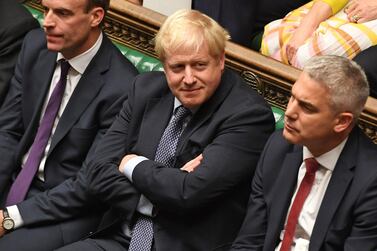 A handout picture released by the UK Parliament shows Britain's Prime Minister Boris Johnson (C) smiling in the House of Commons in London on October 19, 2019, AFP