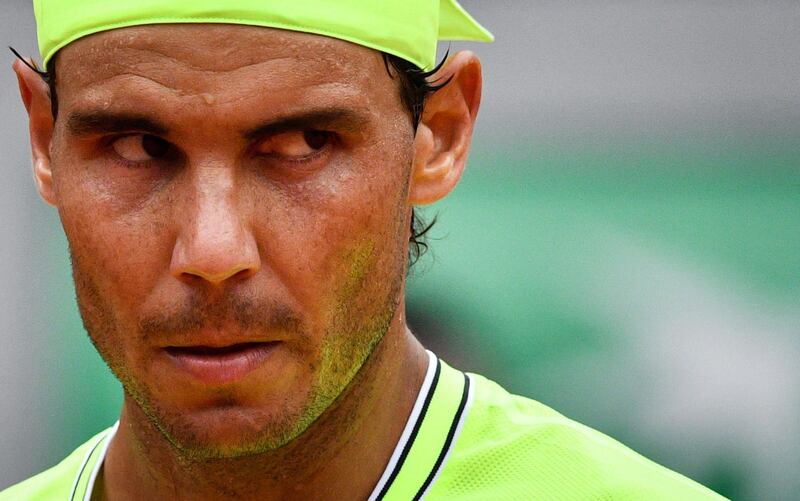 Nadal reacts as he plays against Thiem. AFP