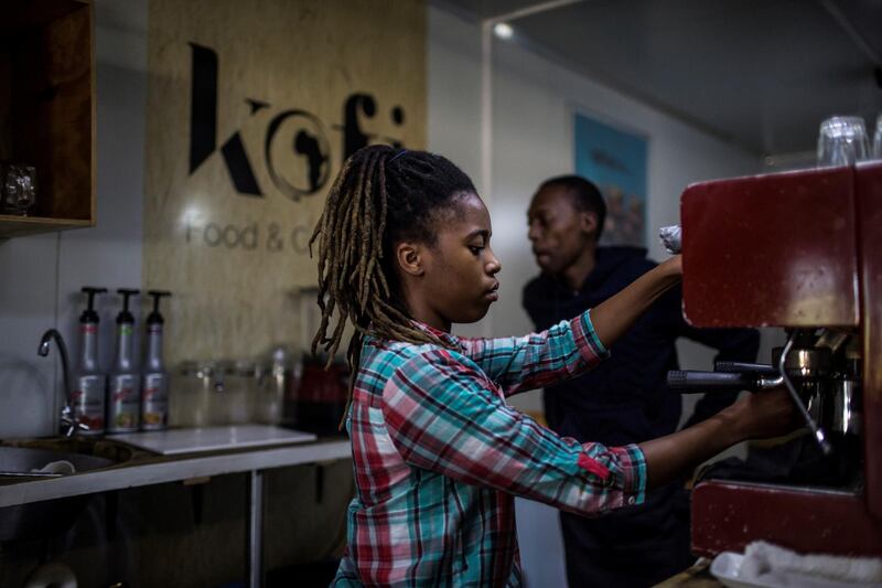 Employees of The Box Shop coffee shop in Vilakazi Street  Soweto in Johannesburg prepare coffee on June 8, 2017.
Soweto's cottage industries are being transformed from individuals making small quantities of items like dresses, furniture and cosmetics for local consumption into booming enterprises with global reach.   / AFP PHOTO / GULSHAN KHAN