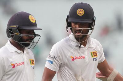 Sri Lanka's captain Dinesh Chandimal, right, and teammate Niroshan Dickwella leave the field at the end of third day's play of the first test cricket match between India and Sri Lanka in Kolkata, India, Saturday, Nov. 18, 2017. (AP Photo/Bikas Das)
