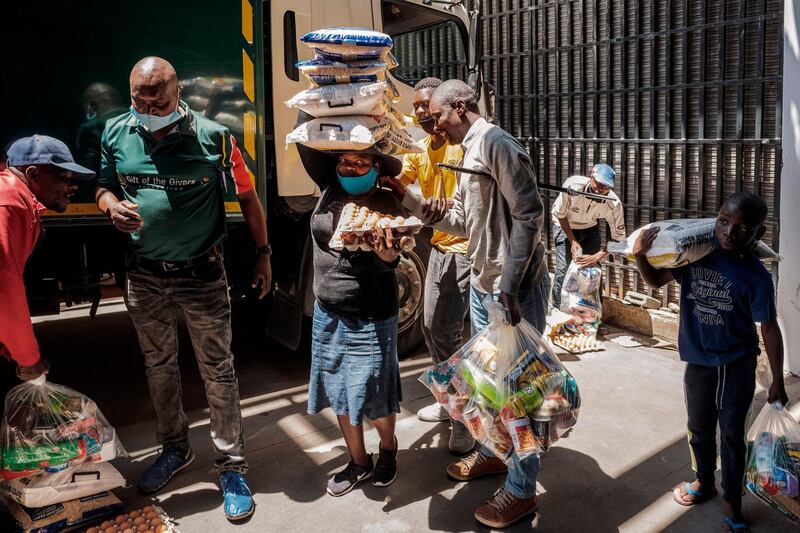 Blind people and their families wait for food parcels during a food distribution organised by Gift of the Givers in Johannesburg CBD. Despite  economic activity opening amid lockdown regulations to curb the spread of the coronavirus, the South Africa's economy is still negatively affected.  AFP