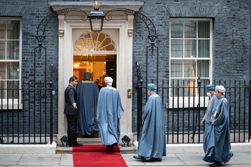 Members of the Sultan of Oman's delegation arrive at 10 Downing Street. PA