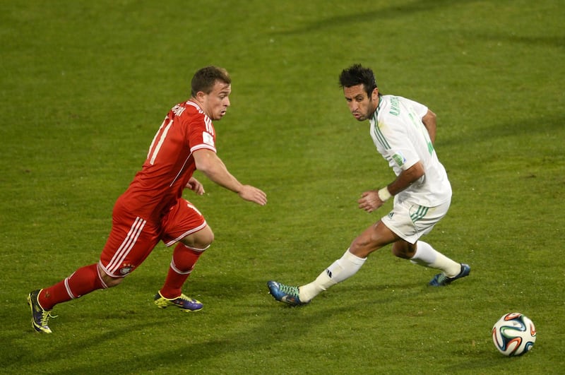 Bayern Munich's Swiss midfielder Xherdan Shaqiri (L) fights for the ball against Morocco Raja Casablanca's defender Adil Karrouchy during their 2013 FIFA Club World Cup final football match in the Moroccan city of Marrakesh, on December 21, 2013. The regional champions from each of the FIFA regions are gathering in the north African country of Morocco to decide which is the best domestic team in the world. AFP PHOTO / ERIC FEFERBERG (Photo by ERIC FEFERBERG / AFP)