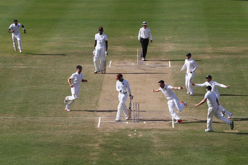 ANTIGUA, ANTIGUA AND BARBUDA - APRIL 17:  James Anderson of England claims the wicket of  Denesh Ramdin of West Indies to pass Ian Botham's record of 383   Test wickets and become England's highest Test wicket bowler during day five of the 1st Test match between West Indies and England at the Sir Vivian Richards Stadium on April 17, 2015 in Antigua, Antigua and Barbuda.  (Photo by Michael Steele/Getty Images)