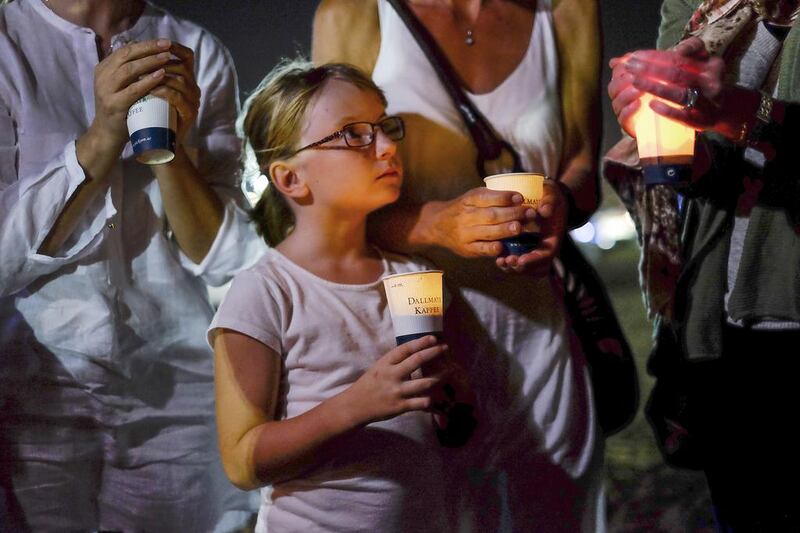 A girl holds a candle during last night’s vigil at  Kite Beach, Jumeirah, for murdered American Ibolya Ryan. Antonie Robertson / The National 