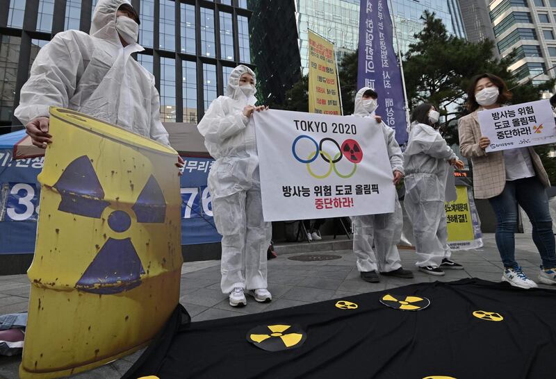 Anti-nuclear activists wearing white protective clothing stage a protest against the Tokyo 2020 Olympic Games. AFP