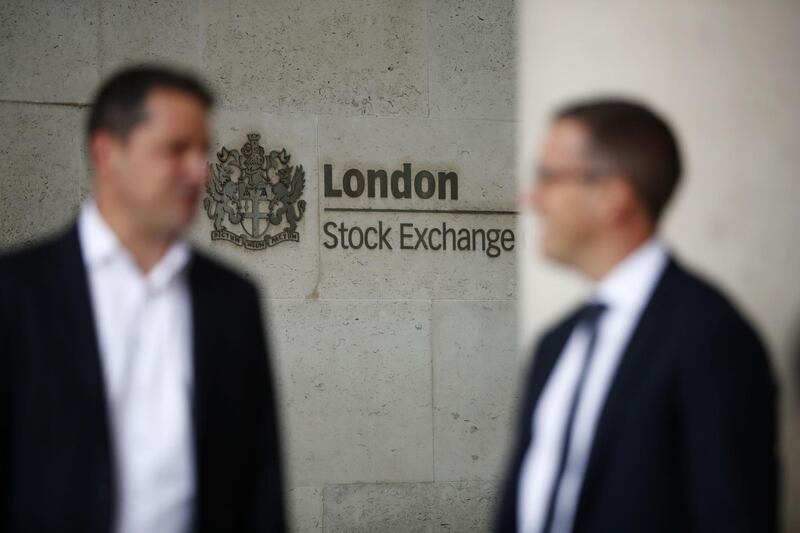 (FILES) In this file photo taken on August 9, 2017 Commuters walk past the London Stock Exchange in the City of London on August 9, 2017.  London Stock Exchange unveiled on August 1, 2019 a $27 billion takeover of US financial data provider Refinitiv that would create a market information giant to rival Bloomberg. / AFP / Tolga AKMEN
