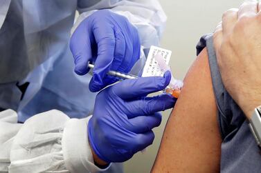 A volunteer receives a shot of Moderna’s experimental Covid-19 vaccine during the first-stage clinical trial in March. AP