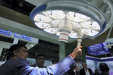 Visitors look at operation theatre lights at the Arab Health conference held at Dubai World Trade Centre in Dubai. Pawan Singh/The National