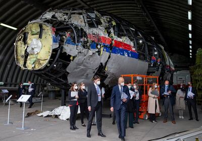 Judges and lawyers view the reconstructed wreckage of Malaysia Airlines Flight MH17. AP
