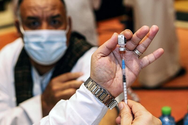 A health worker prepares a dose of the Pfizer-BioNTech Covid-19 vaccine at a vaccination centre in Kuwait City. AFP