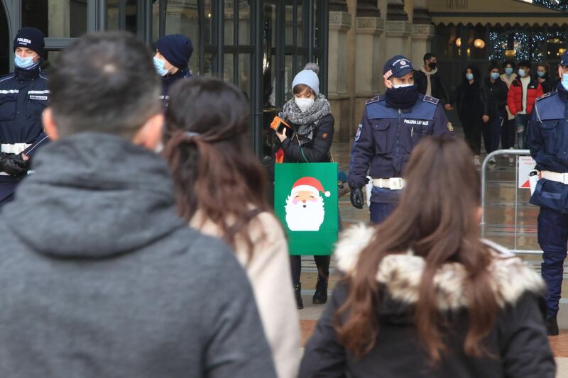 Local police on duty at an entrance to the Galleria Vittorio Emanuele II to limit the quota of people accessing the shopping mall in Milan, northern Italy. EPA