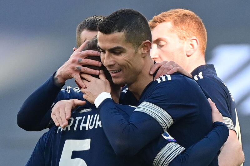 Juventus' Cristiano Ronaldo celebrates with midfielder Arthur his goal. AFP