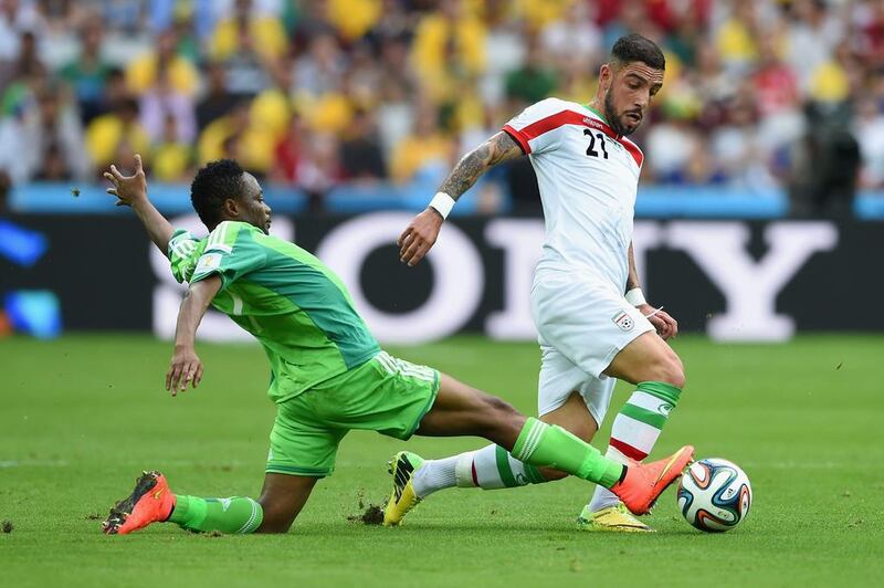 Ashkan Dejagah of Iran is challenged by Ahmed Musa of Nigeria during their scoreless draw in Group F play at the 2014 World Cup in Curitiba, Brazil on Monday. Matthias Hangst / Getty Images
